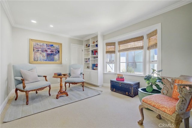 sitting room featuring built in shelves, ornamental molding, and carpet flooring