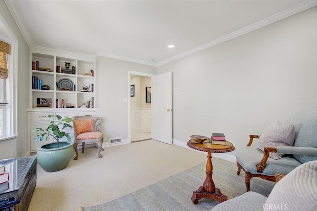 living area featuring carpet and ornamental molding