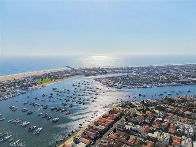 aerial view with a water view and a beach view