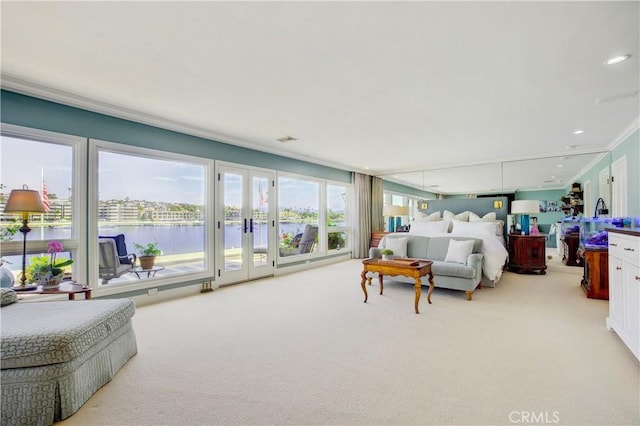 carpeted bedroom with a water view, access to exterior, and crown molding