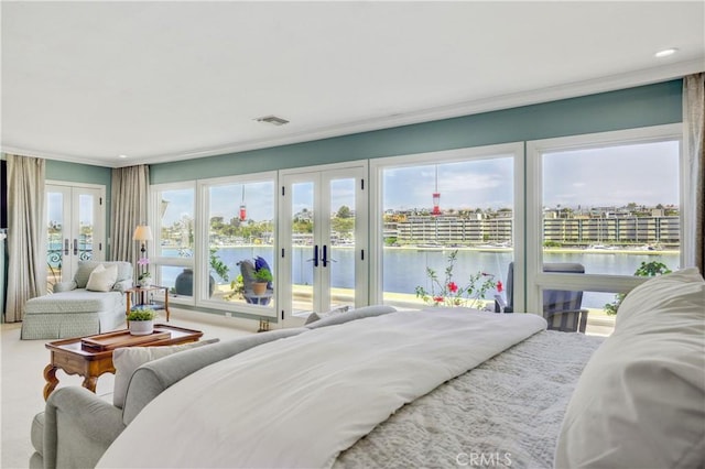 bedroom featuring access to outside, ornamental molding, a water view, and french doors