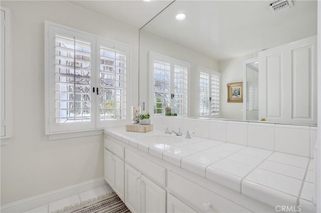 bathroom featuring tile patterned flooring, french doors, and vanity