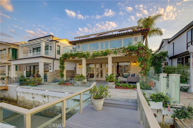 rear view of property featuring french doors