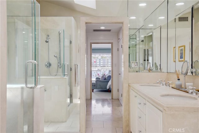 bathroom featuring vanity, tile patterned flooring, and an enclosed shower