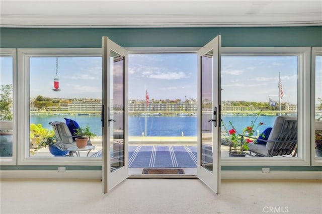 doorway with a water view, french doors, and carpet flooring