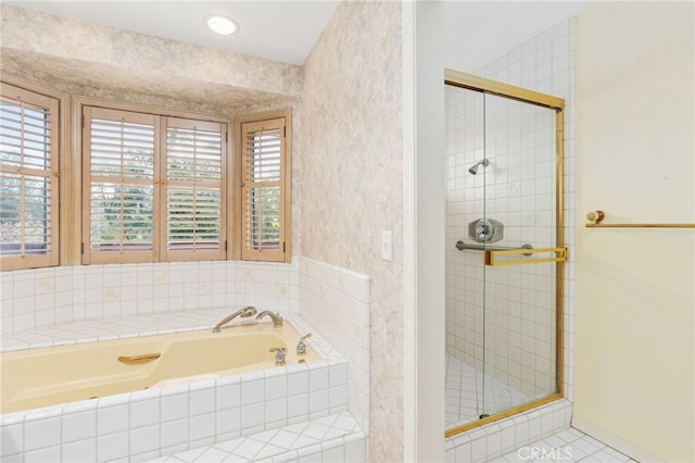 bathroom with shower with separate bathtub and tile patterned floors