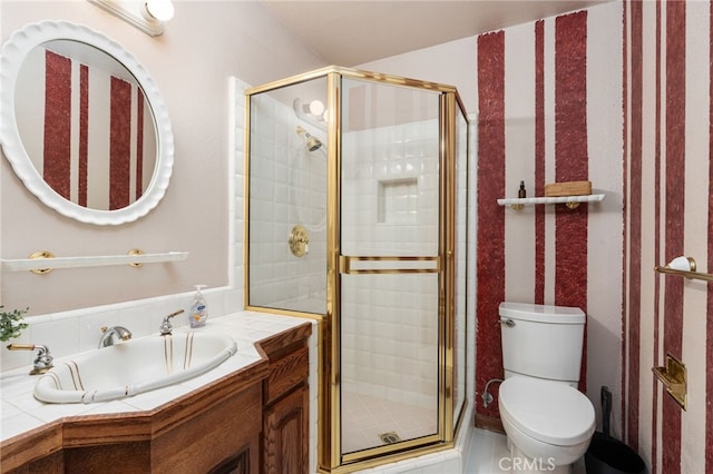 bathroom with vanity, toilet, and an enclosed shower