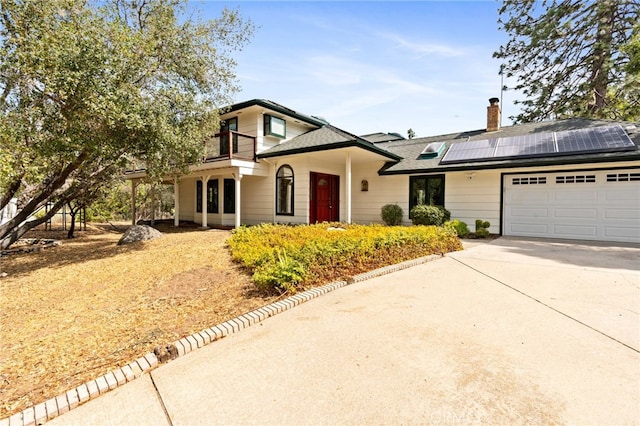 view of front of house featuring a garage and solar panels