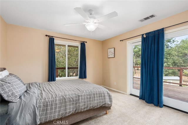 carpeted bedroom featuring multiple windows, ceiling fan, and access to exterior