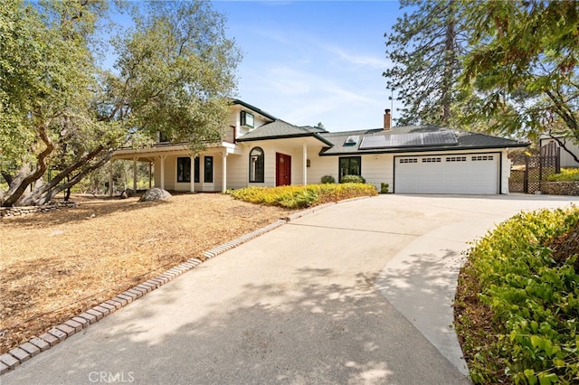 view of front of home with solar panels and a garage