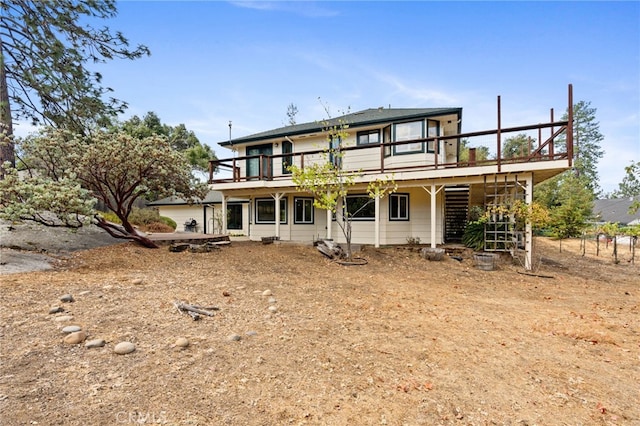 rear view of property featuring a wooden deck