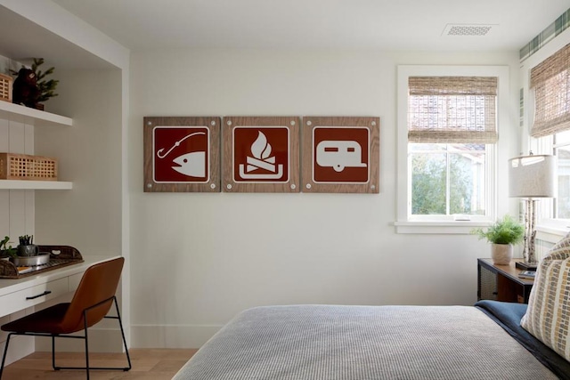 bedroom featuring multiple windows and light hardwood / wood-style floors