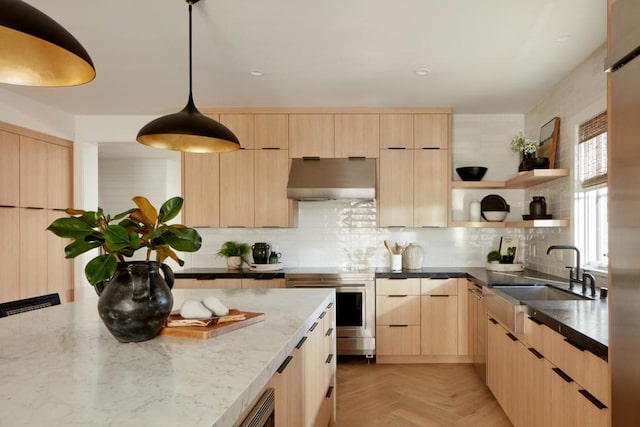 kitchen with light parquet floors, sink, exhaust hood, light brown cabinets, and decorative light fixtures