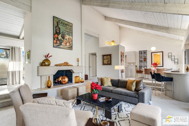 living room with high vaulted ceiling, carpet floors, beam ceiling, and wood ceiling