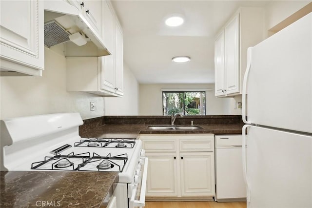 kitchen with sink, white appliances, and white cabinetry