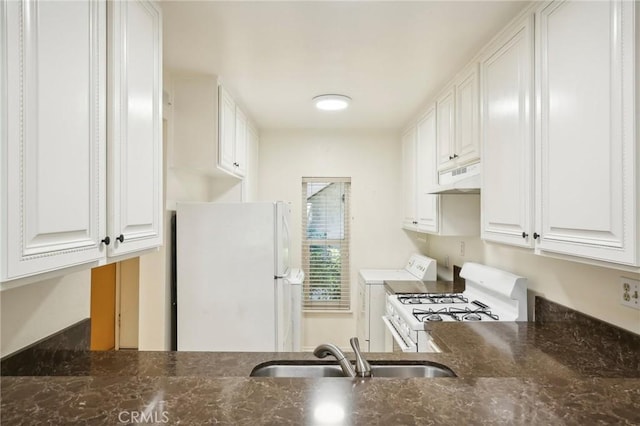 kitchen featuring white cabinetry, sink, white appliances, and washer / dryer