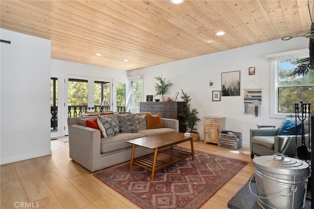 living room with light hardwood / wood-style floors, wooden ceiling, and a healthy amount of sunlight