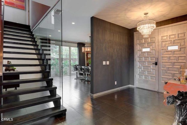 foyer featuring wooden walls and an inviting chandelier