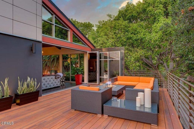 deck at dusk with outdoor lounge area