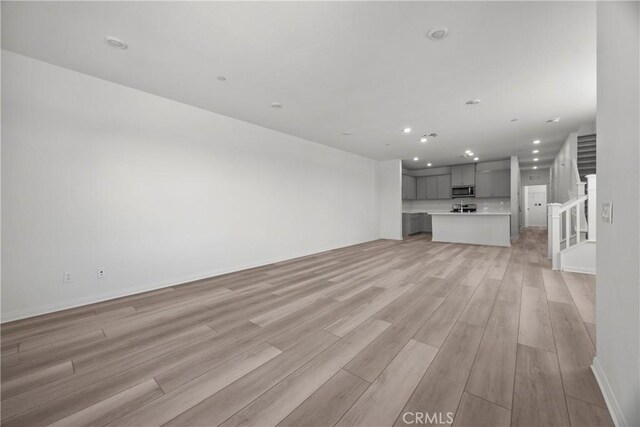 unfurnished living room featuring light hardwood / wood-style flooring