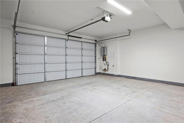 garage featuring a garage door opener and water heater