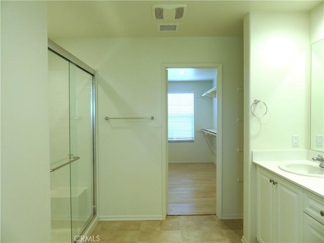 bathroom featuring vanity, hardwood / wood-style flooring, and walk in shower