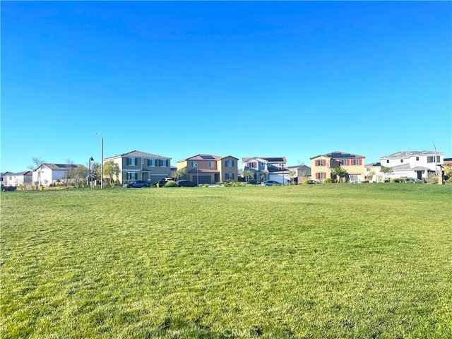 view of home's community with a lawn