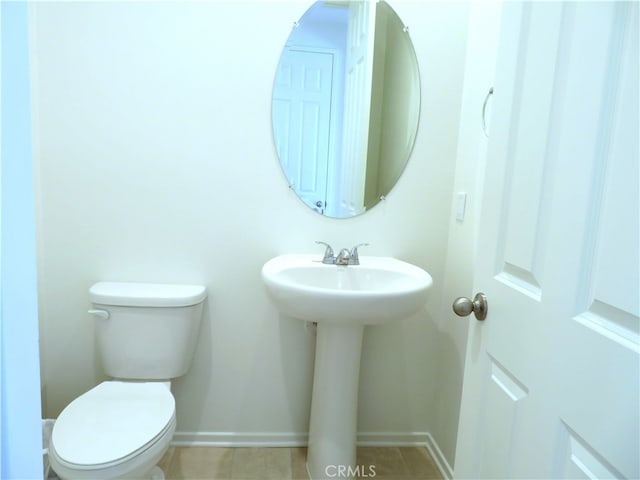 bathroom with tile patterned flooring and toilet