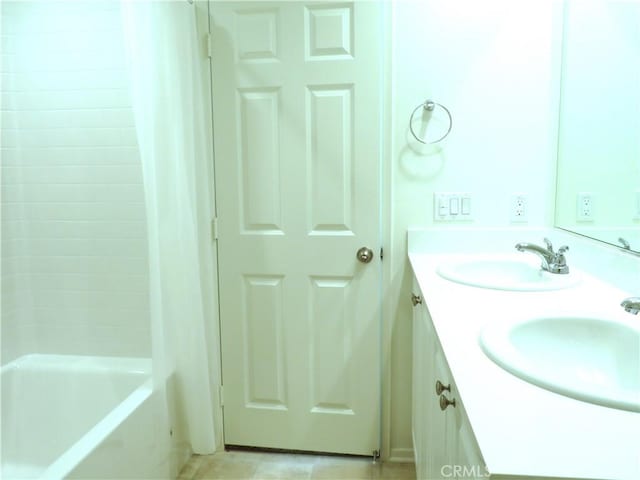 bathroom with tile patterned flooring and vanity