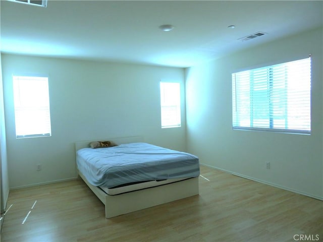 bedroom with light wood-type flooring