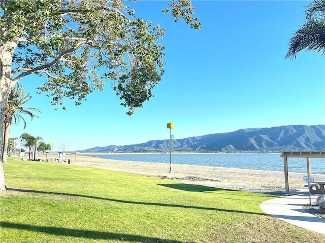 view of home's community featuring a lawn and a water and mountain view