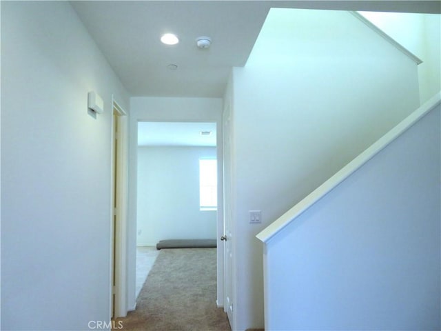 corridor with light colored carpet