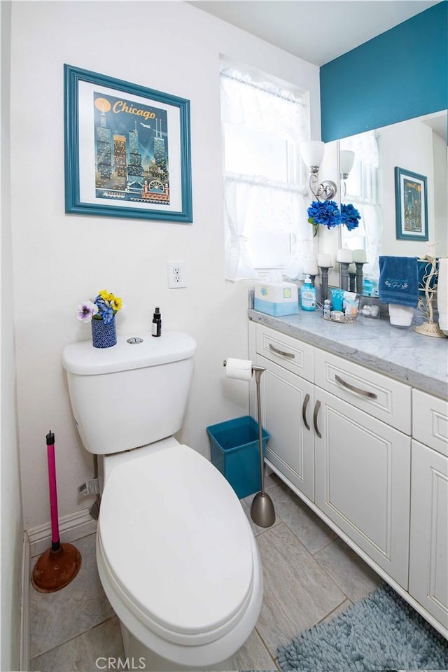 bathroom with tile patterned floors, vanity, and toilet