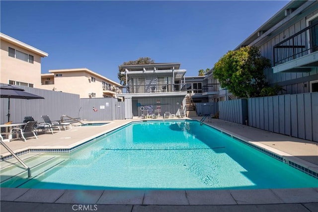 view of pool featuring a patio and a hot tub