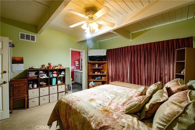 carpeted bedroom with beamed ceiling, ceiling fan, wooden ceiling, and ensuite bathroom