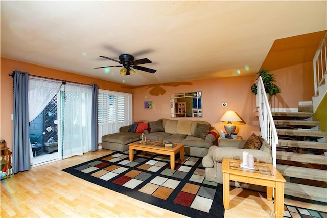 living room with ceiling fan and light hardwood / wood-style flooring