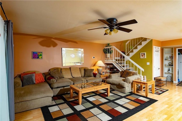 living room with ceiling fan and light hardwood / wood-style flooring