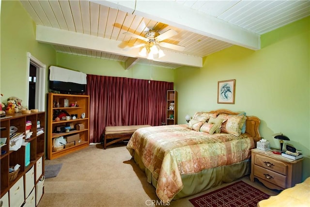 bedroom with beamed ceiling, light carpet, ceiling fan, and wooden ceiling