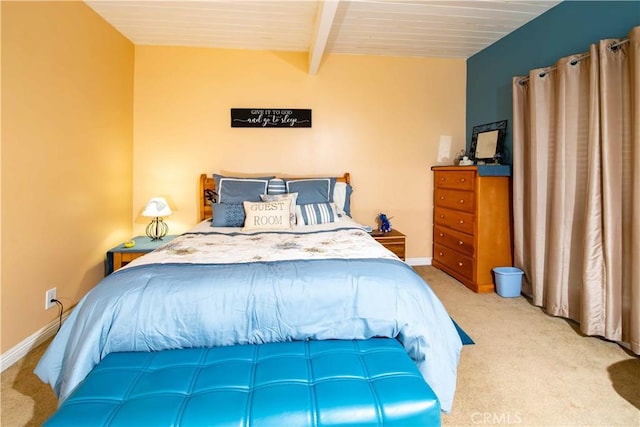 bedroom with light carpet and beamed ceiling