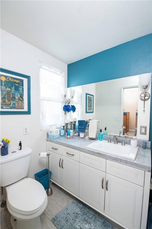 bathroom with tile patterned floors, vanity, and toilet