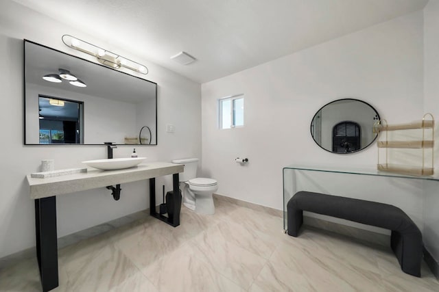 bathroom with toilet and sink