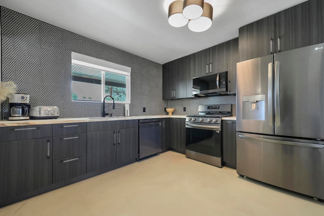 kitchen with appliances with stainless steel finishes, decorative backsplash, and sink