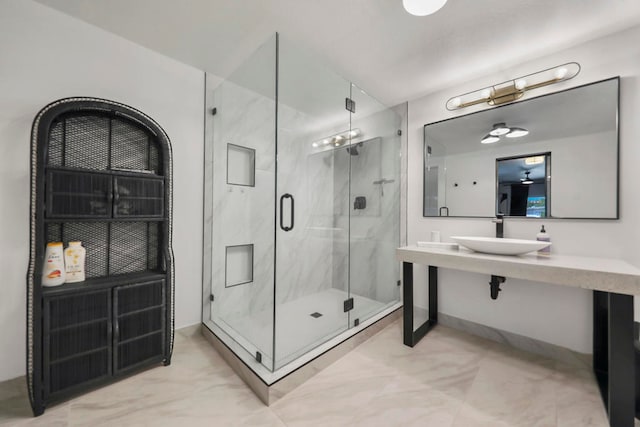 bathroom with walk in shower and sink