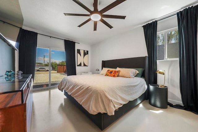 bedroom with access to outside, concrete flooring, multiple windows, and ceiling fan