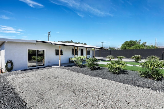 back of property with a patio