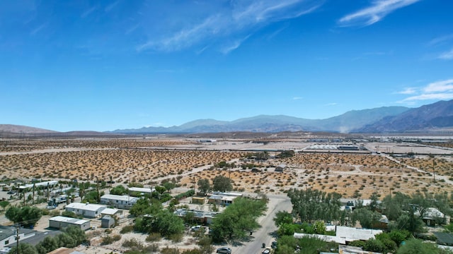 birds eye view of property featuring a mountain view