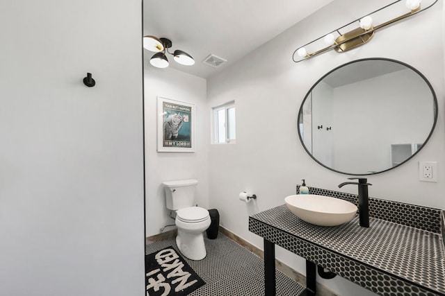 bathroom with tile patterned flooring, toilet, and sink