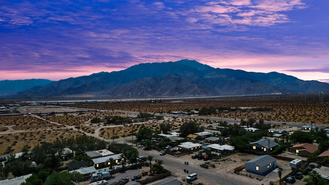 aerial view at dusk featuring a mountain view