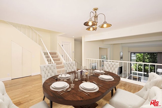 dining room with a chandelier and light wood-type flooring