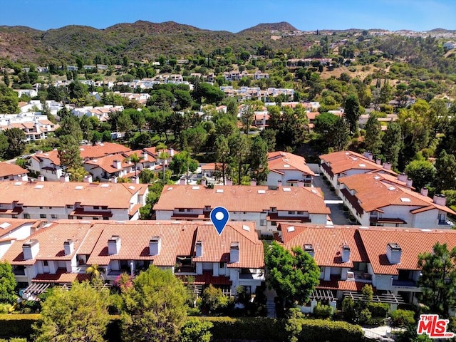 birds eye view of property with a mountain view